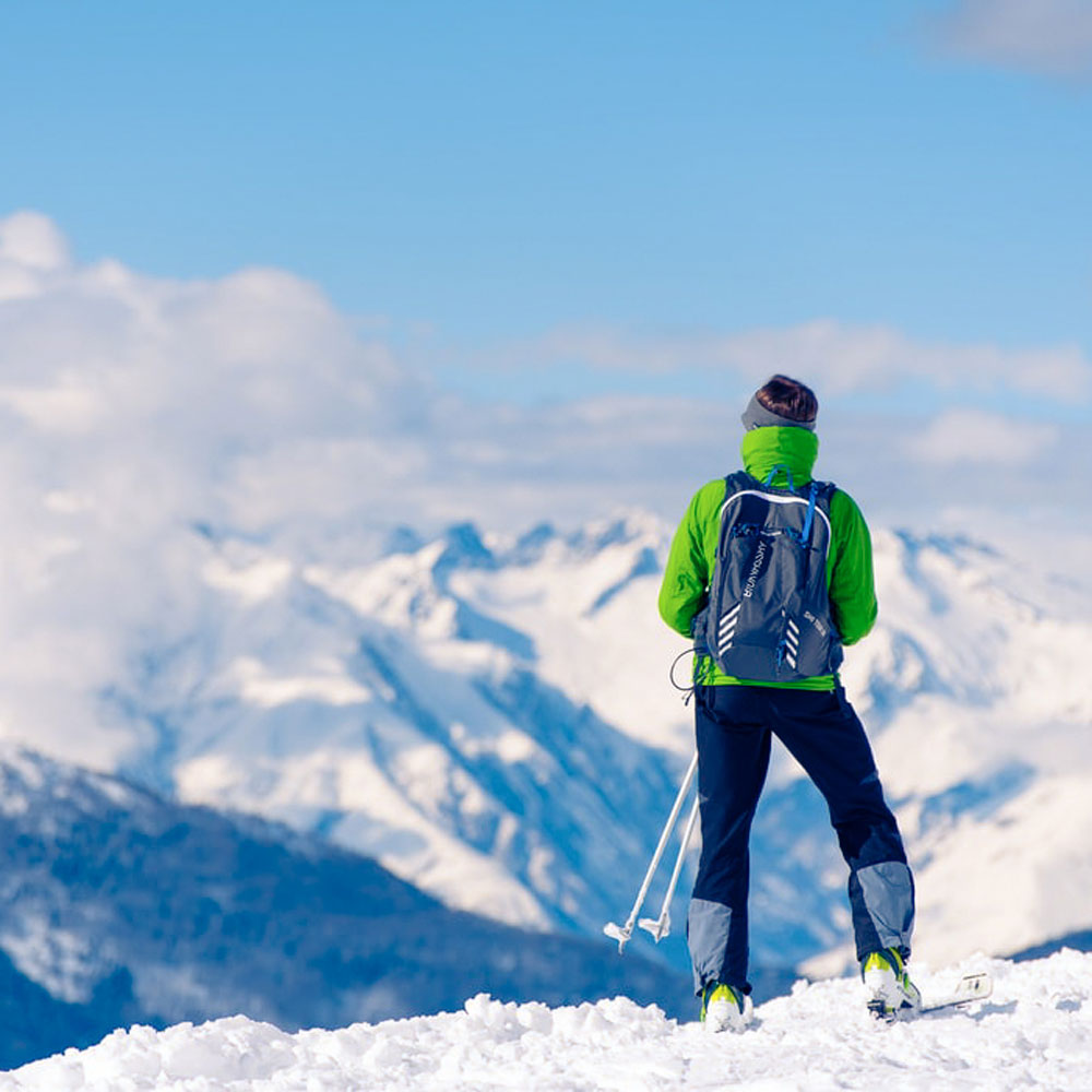 Person taking break from skiing looking off at snowy mountains #1-wahle-dein-profil_high